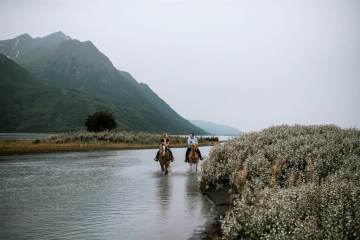 a person riding a horse in a body of water