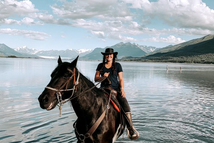 a person riding a horse in a body of water