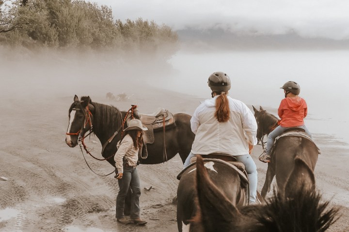 a group of people riding on the back of a horse
