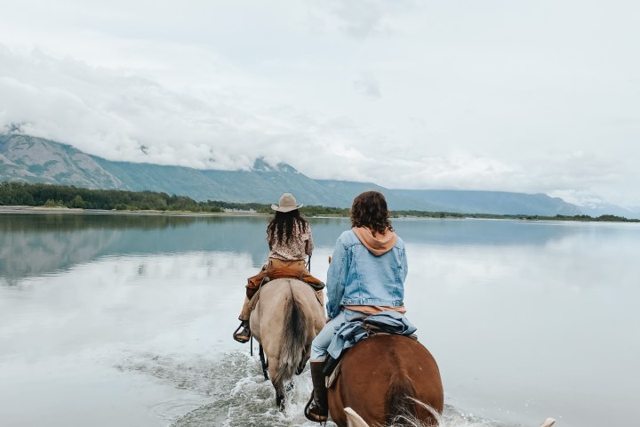 a person riding a horse in a body of water